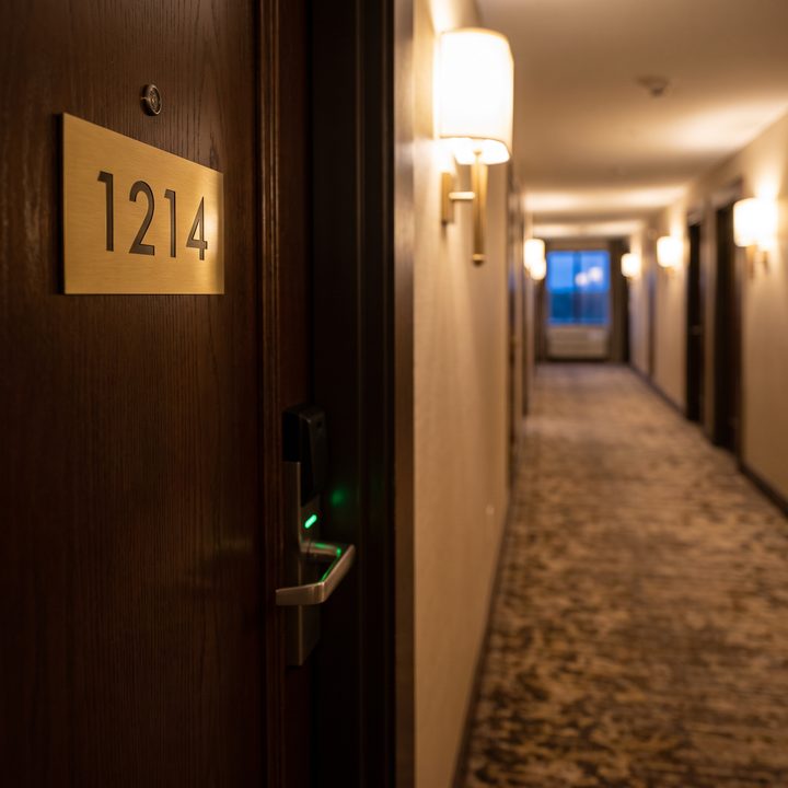 A hotel room door with the number 1214 and a key card lock